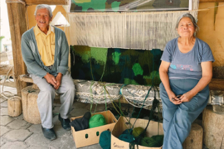 Pareja de artesanos muestra su progreso en la nueva alfombra. Guano, Ecuador.