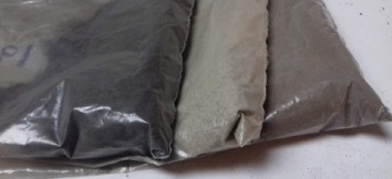Dried, ground, and sifted
compounded soil samples in labeled airtight plastic bags. Here we see three
samples at three different depths of the same site.